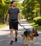 Man smiling while walking a large German Shepherd on the TrailTether hands-free leash
